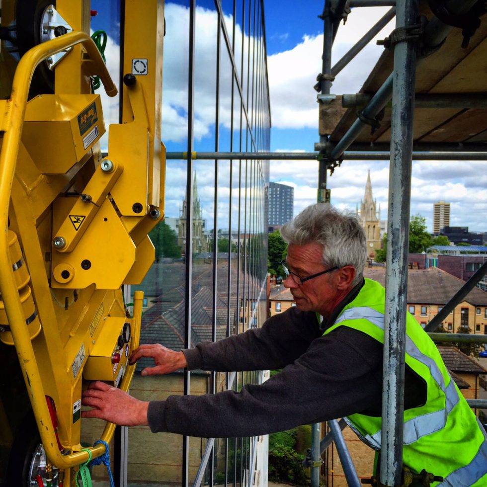 close up of installing glass window high up