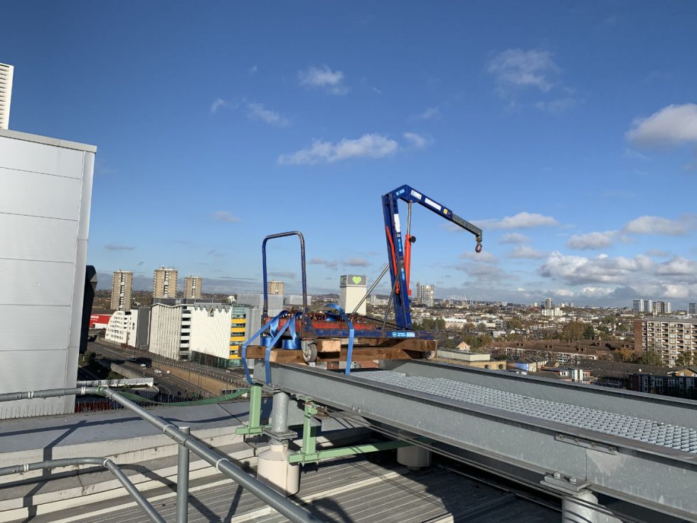 glass lifting machine strapped to a roof