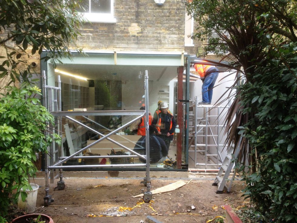installation of huge glass window with view of kitchen